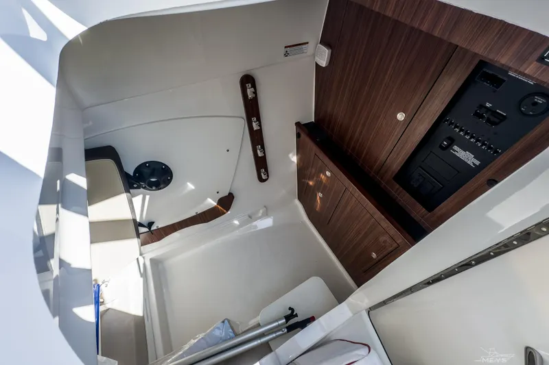 Slide: The Image of 2021 Pursuit DC 326 Dual Console interior with wood paneling and control panel. - 15