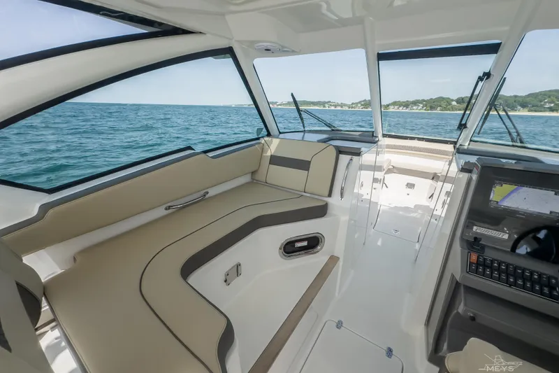 Slide: The Image of 2021 Pursuit DC 326 Dual Console interior with ocean view and modern dashboard. - 9