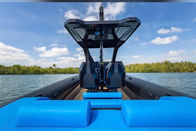 Slide: The Image of 2025 Technohull 38 Gran boat on water, featuring sleek design and vibrant blue seating. - 17