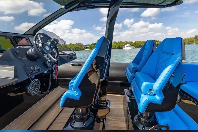 Slide: The Image of Interior of 2025 Technohull 38 Gran boat with blue seats and modern dashboard. - 18