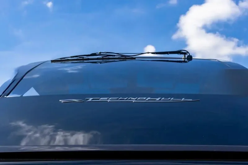 Slide: The Image of 2025 Technohull 38 Gran windshield with logo against blue sky. - 19