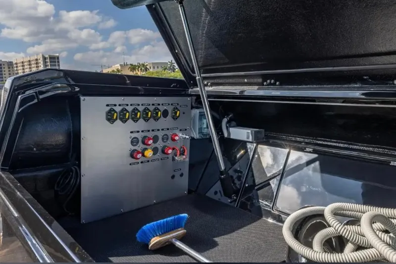 Slide: The Image of Control panel of 2025 Technohull 38 Gran boat with open hatch and cleaning tools. - 24