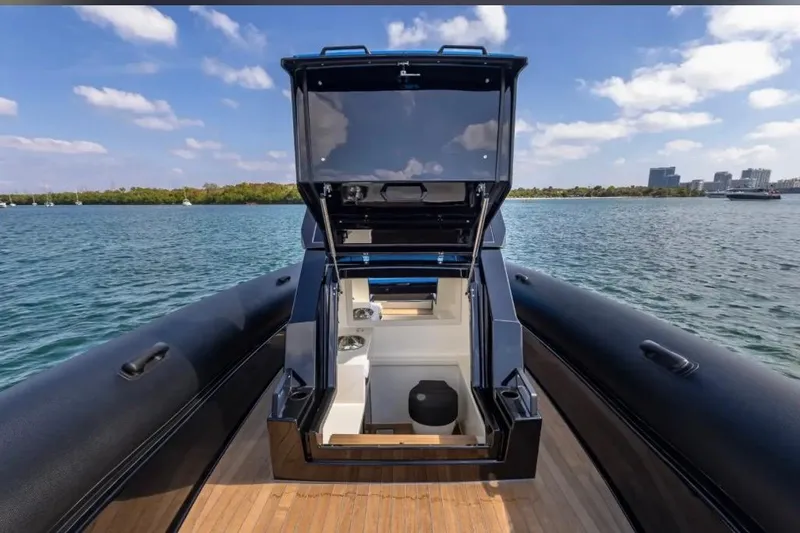 Slide: The Image of 2025 Technohull 38 Gran yacht with open storage compartment on a sunny day. - 26