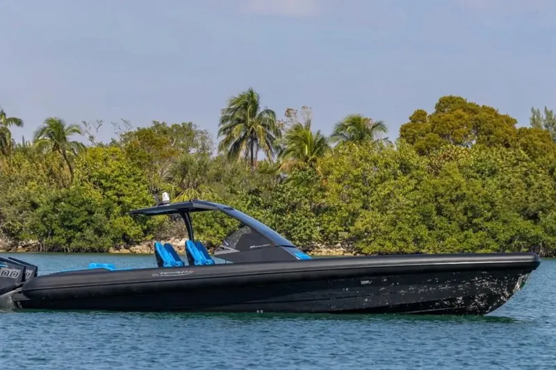 Slide: The Image of 2025 Technohull 38 Gran boat on water, surrounded by lush greenery and clear skies. - 7