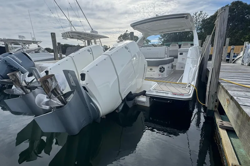 Slide: The Image of 2025 Sea Ray SLX 400 Outboard docked, showcasing powerful engines and spacious deck. - 11