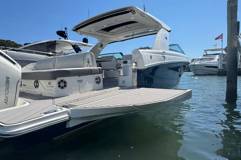 Slide: The Image of 2025 Sea Ray SLX 400 Outboard luxury boat docked, featuring spacious deck and modern design. - 12