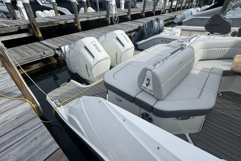 Slide: The Image of 2025 Sea Ray SLX 400 Outboard with dual engines docked at marina. - 15