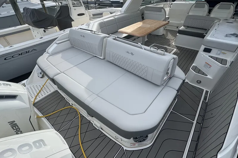 Slide: The Image of 2025 Sea Ray SLX 400 Outboard luxury boat interior with seating and table. - 16