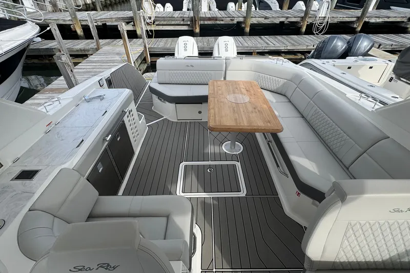 Slide: The Image of Luxurious 2025 Sea Ray SLX 400 Outboard boat interior with elegant seating and wooden table. - 22