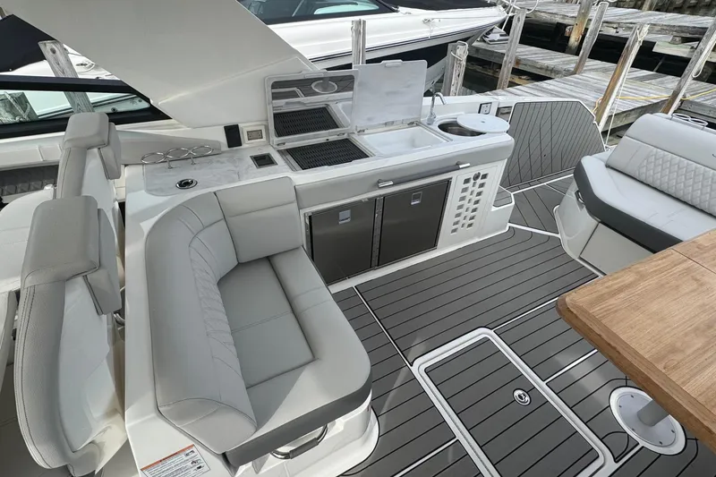 Slide: The Image of 2025 Sea Ray SLX 400 Outboard interior with sleek seating and modern amenities. - 24