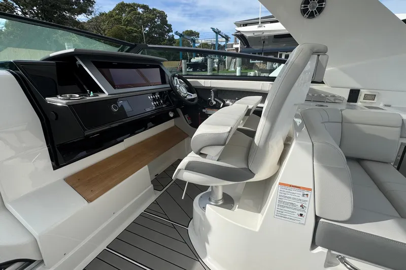 Slide: The Image of 2025 Sea Ray SLX 400 Outboard cockpit with modern helm and luxurious seating. - 30