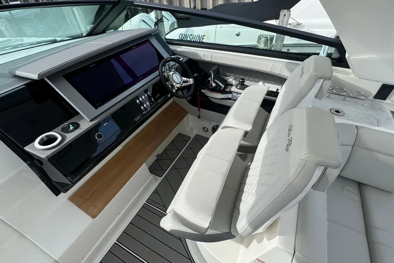 Slide: The Image of 2025 Sea Ray SLX 400 Outboard helm with modern controls and luxurious seating. - 31