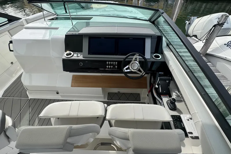 Slide: The Image of 2025 Sea Ray SLX 400 Outboard helm with modern controls and dual screens. - 32