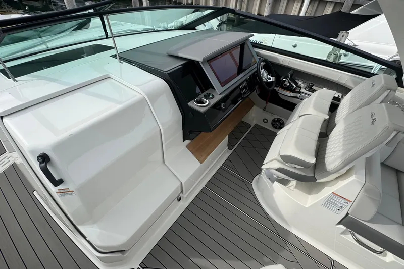 Slide: The Image of 2025 Sea Ray SLX 400 Outboard cockpit with modern dashboard and luxurious seating. - 33