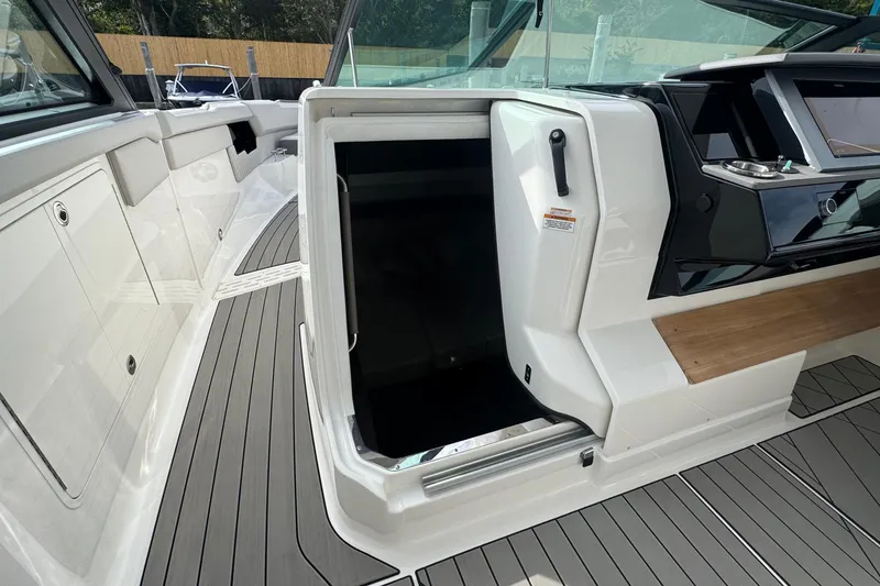 Slide: The Image of 2025 Sea Ray SLX 400 Outboard interior with open cabin door and sleek design. - 34