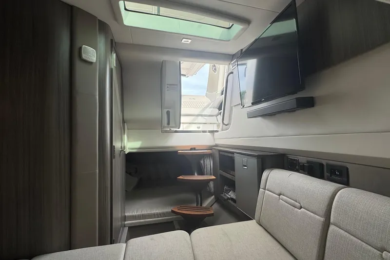 Slide: The Image of Interior of 2025 Sea Ray SLX 400 Outboard, featuring modern seating and entertainment system. - 39