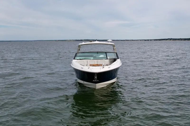 Slide: The Image of 2025 Sea Ray SLX 400 Outboard boat on open water, front view. - 4