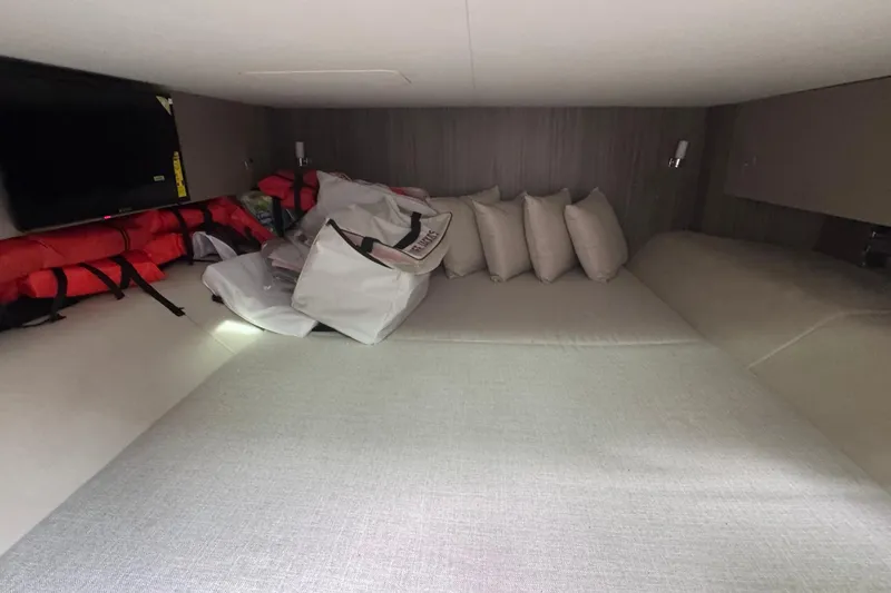 Slide: The Image of 2025 Sea Ray SLX 400 Outboard cabin with cushions and life jackets. - 41