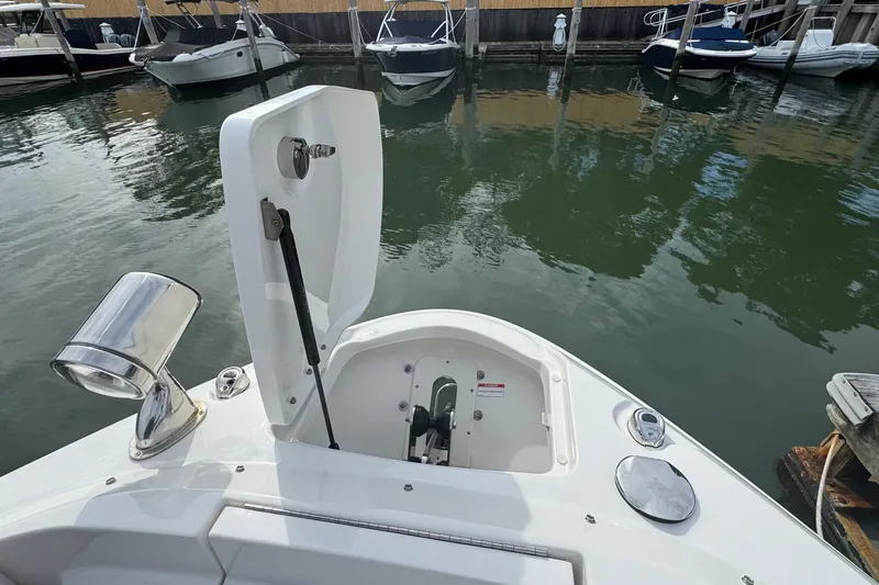 Slide: The Image of 2025 Sea Ray SLX 400 Outboard boat with open hatch at marina. - 48