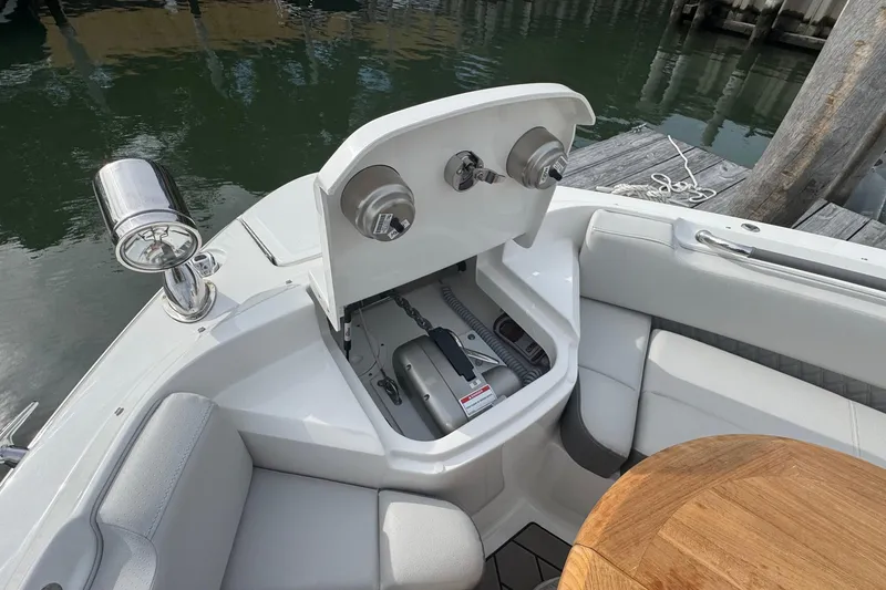 Slide: The Image of 2025 Sea Ray SLX 400 Outboard boat interior with open storage compartment and seating area. - 49