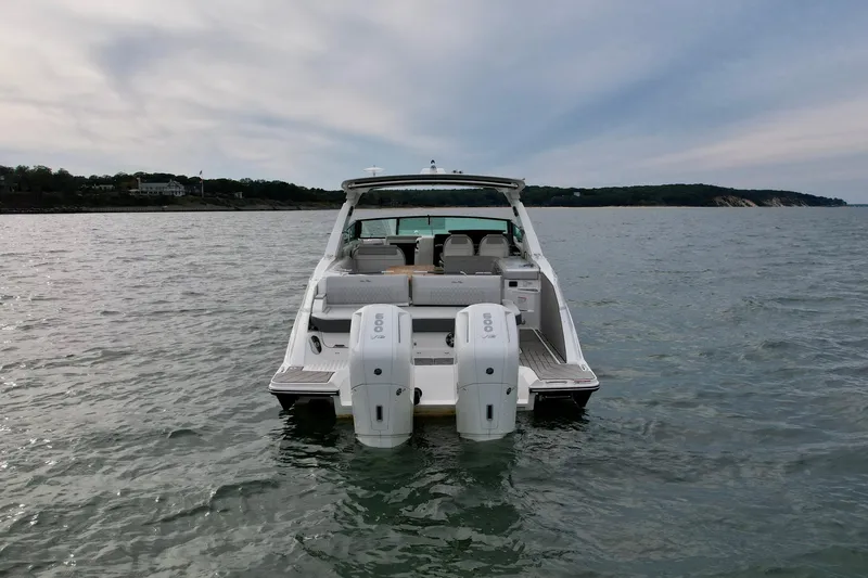 Slide: The Image of 2025 Sea Ray SLX 400 Outboard on water, rear view, dual engines visible. - 5