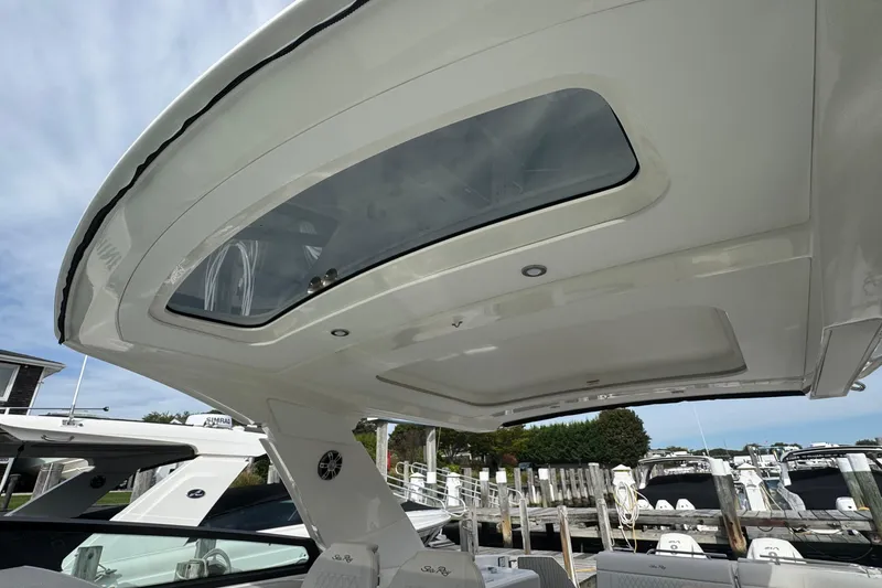 Slide: The Image of 2025 Sea Ray SLX 400 Outboard boat with sleek roof design and skylight. - 53