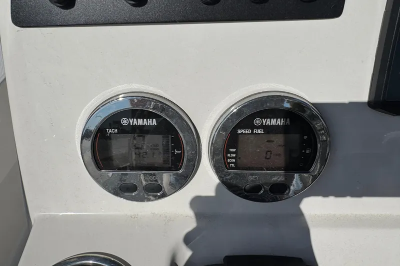 Slide: The Image of Yamaha gauges on 2023 Robalo 206 Cayman boat dashboard, displaying tachometer and speed fuel data. - 18
