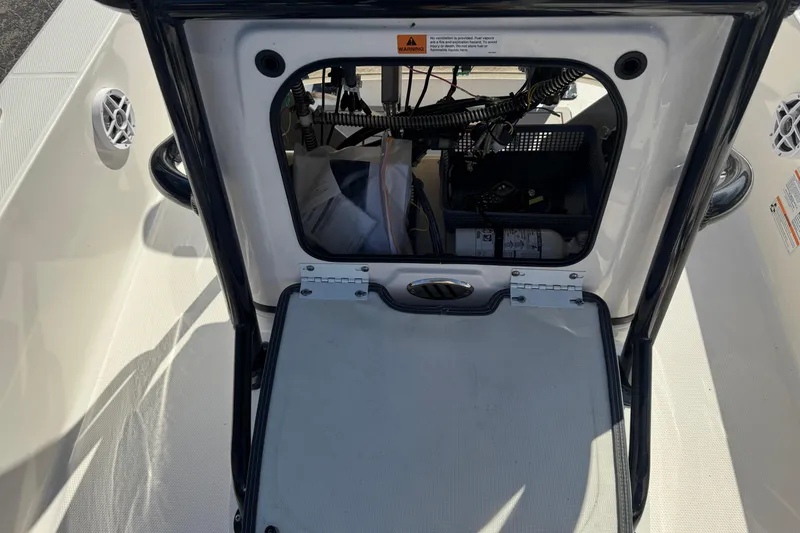 Slide: The Image of 2023 Robalo 206 Cayman boat storage compartment with wiring and equipment. - 23