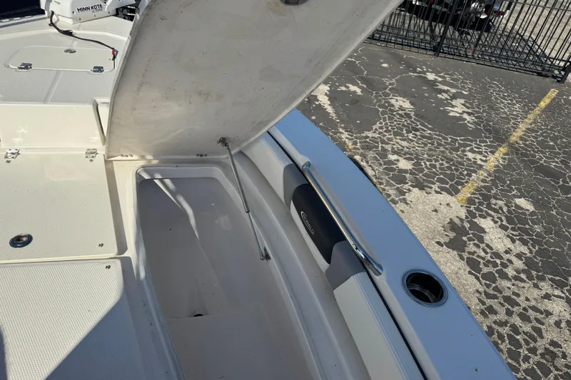 Slide: The Image of 2023 Robalo 206 Cayman boat storage compartment open, showcasing interior space. - 32