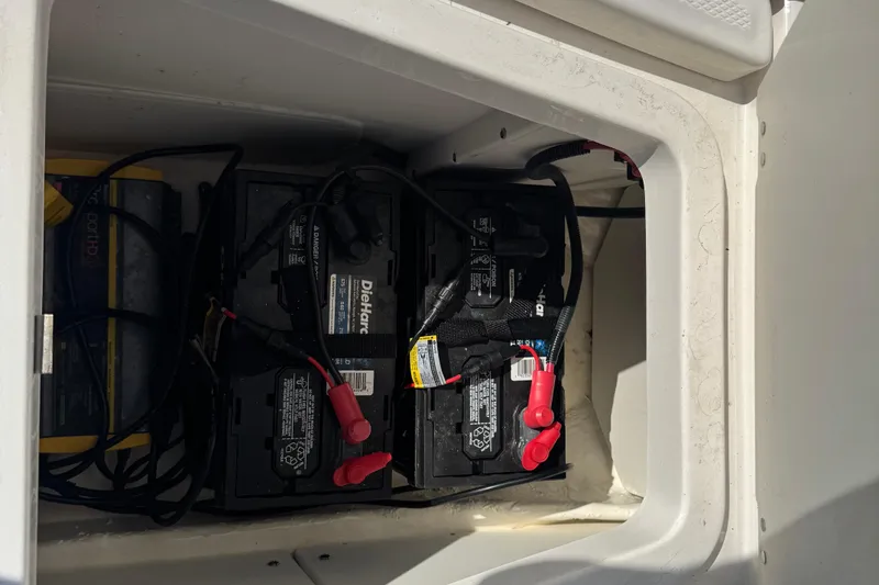 Slide: The Image of Battery compartment of 2023 Robalo 206 Cayman boat with DieHard batteries. - 33