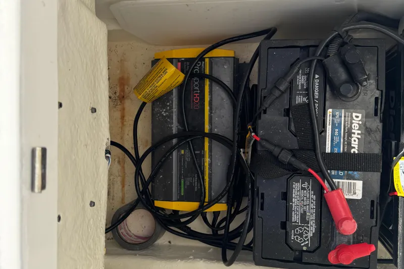 Slide: The Image of Battery compartment of 2023 Robalo 206 Cayman with DieHard battery and charger. - 34