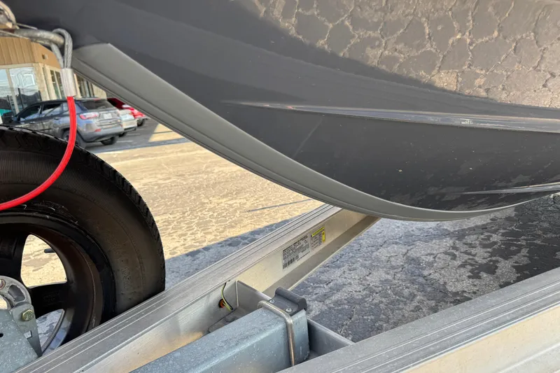 Slide: The Image of 2023 Robalo 206 Cayman boat hull on trailer, close-up view. - 4