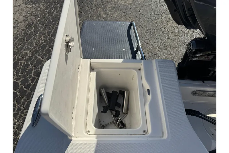Slide: The Image of Open storage compartment on 2023 Robalo 206 Cayman boat, showing interior contents. - 42