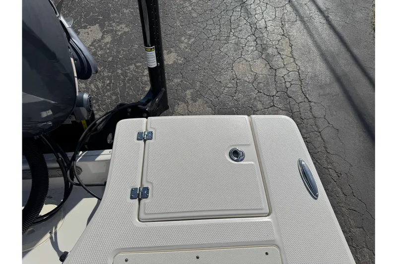 Slide: The Image of 2023 Robalo 206 Cayman boat deck with storage compartment and motor. - 43