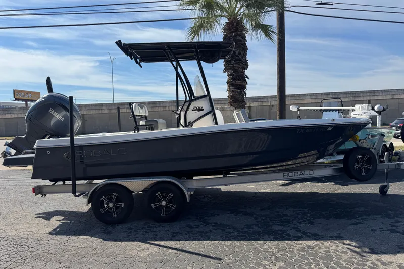 Slide: The Image of 2023 Robalo 206 Cayman boat on trailer with Yamaha engine, parked outdoors. - 45
