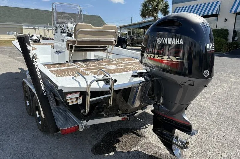 Slide: The Image of 2022 Xpress H22B Bay boat with Yamaha 175 engine, parked outdoors. - 1