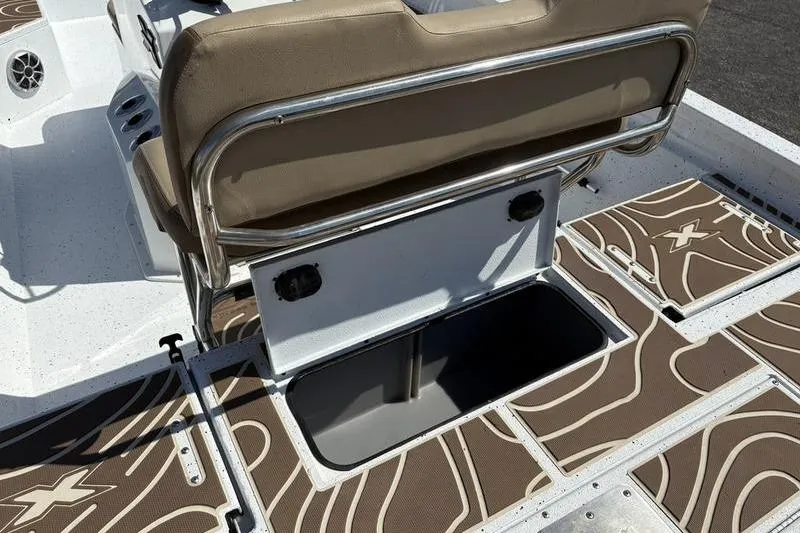 Slide: The Image of 2022 Xpress H22B Bay boat interior with storage compartment and cushioned seating. - 11