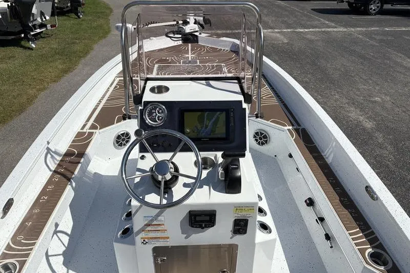 Slide: The Image of 2022 Xpress H22B Bay boat dashboard with steering wheel and navigation display. - 12