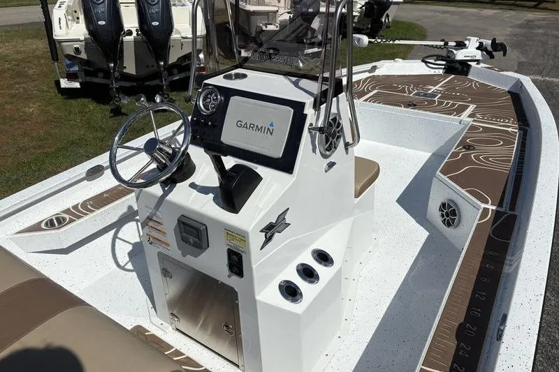 Slide: The Image of 2022 Xpress H22B Bay boat interior with Garmin navigation system and steering console. - 16