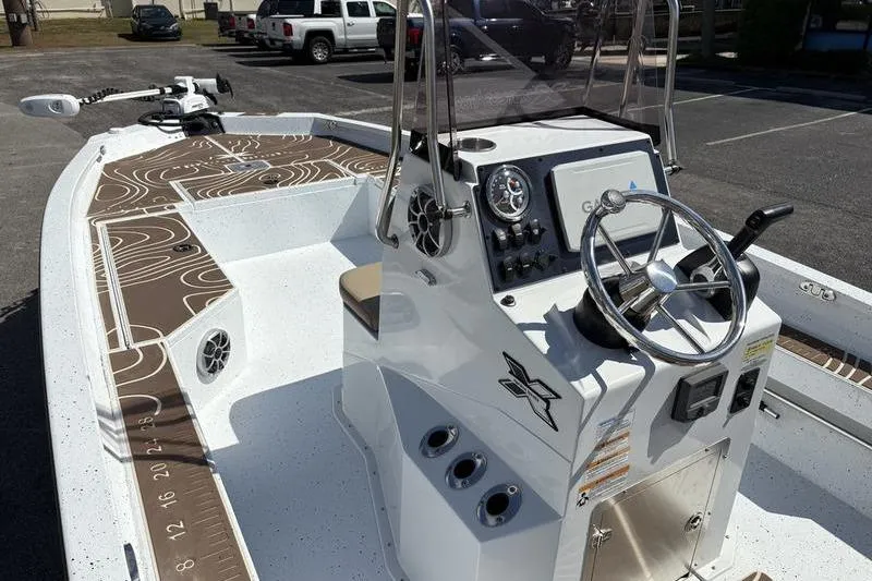 Slide: The Image of 2022 Xpress H22B Bay boat with modern console and steering wheel. - 17
