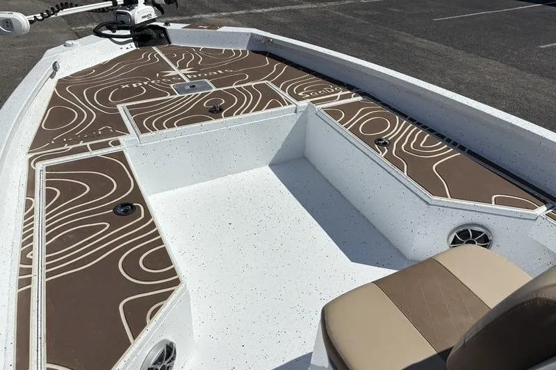 Slide: The Image of 2022 Xpress H22B Bay boat interior with patterned deck and seating. - 18