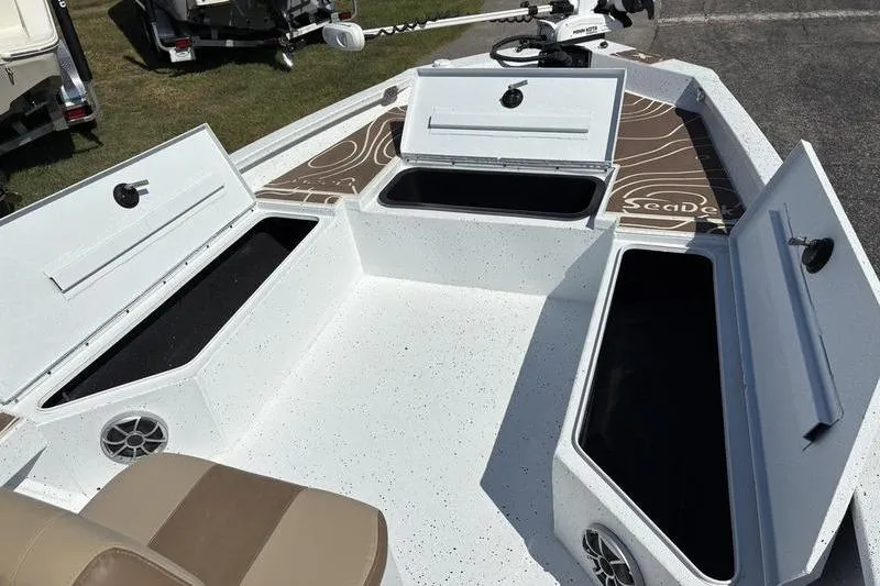 Slide: The Image of 2022 Xpress H22B Bay boat interior with open storage compartments and seating. - 21