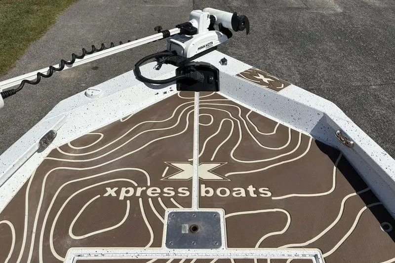 Slide: The Image of 2022 Xpress H22B Bay boat deck with logo and trolling motor. - 22