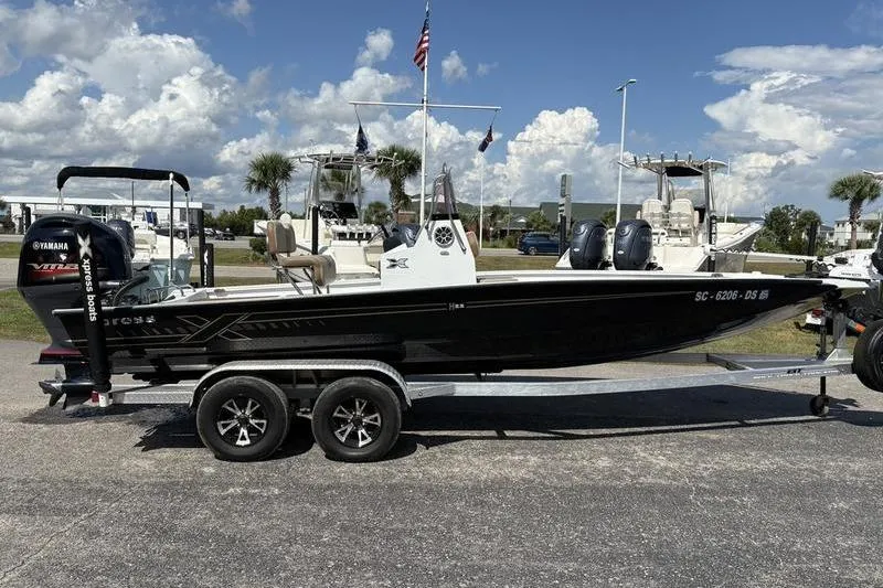 Slide: The Image of 2022 Xpress H22B Bay boat on trailer, parked outdoors under a clear sky. - 4