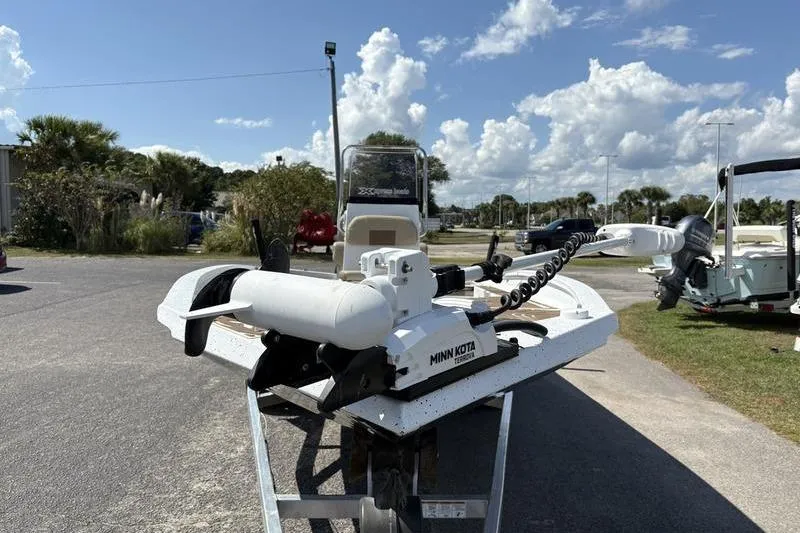 Slide: The Image of 2022 Xpress H22B Bay boat with Minn Kota trolling motor on a sunny day. - 6