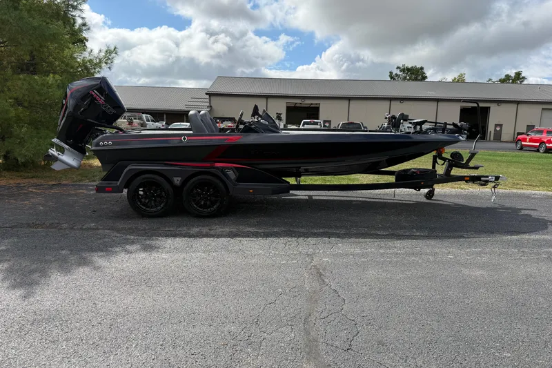 The Image of 2026 iKon LXE21 boat on trailer, parked outdoors near industrial building. - 1