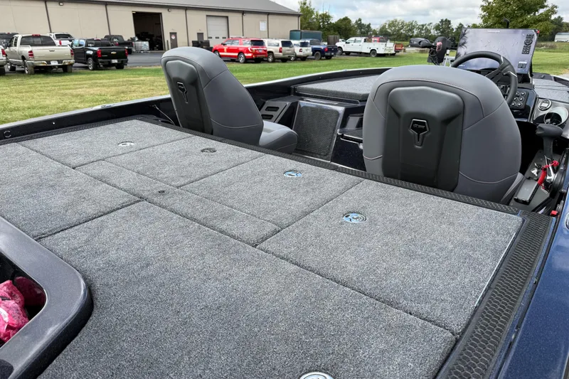 Slide: The Image of 2026 iKon LXE21 boat interior with gray carpeted deck and dual seats. - 13