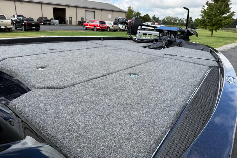 Slide: The Image of 2026 iKon LXE21 boat deck with carpeted surface and mounted equipment, parked near a building. - 14