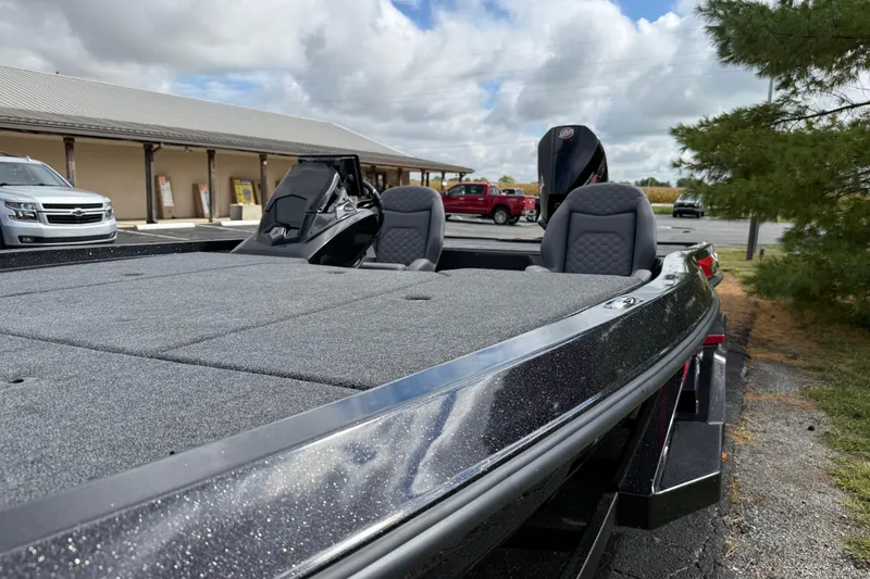 Slide: The Image of 2026 iKon LXE21 boat with sleek design, parked outdoors under cloudy sky. - 15