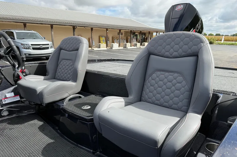 Slide: The Image of Luxury boat seats in a 2026 iKon LXE21, featuring sleek gray upholstery and hexagonal stitching. - 17